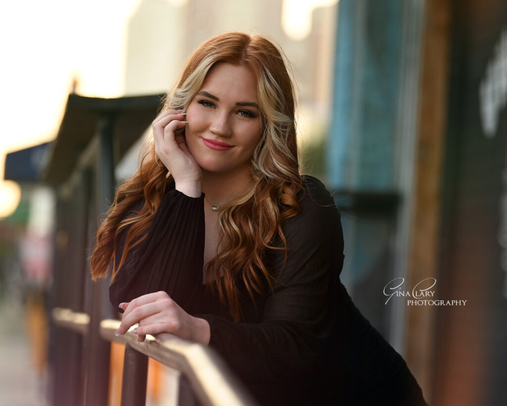 A bold senior portrait in front of one of Deep Ellum’s iconic murals